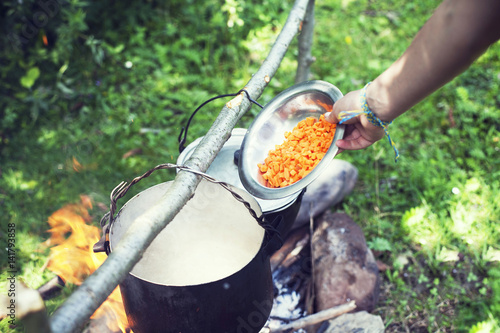 Cooking in a hiking trip, eating in the mountains, tourism. Cooking at the stake.