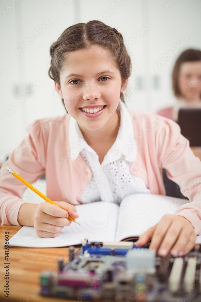 Schoolgirl working on electronic project in classroom Schoolgirl working on electronic project in classroom