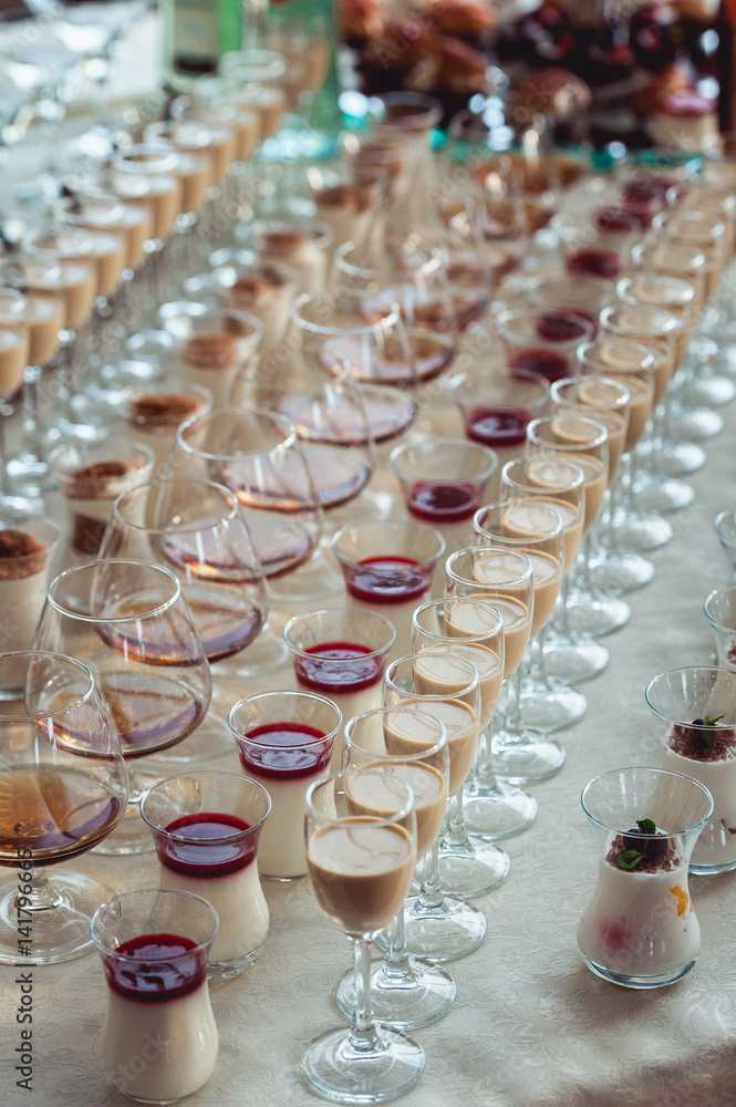 Beautiful row line of different colored alcohol cocktails on a party, Whisky cognac, liquor. Beautiful row line of different colored alcohol cocktails on a party, Whisky cognac, liquor.