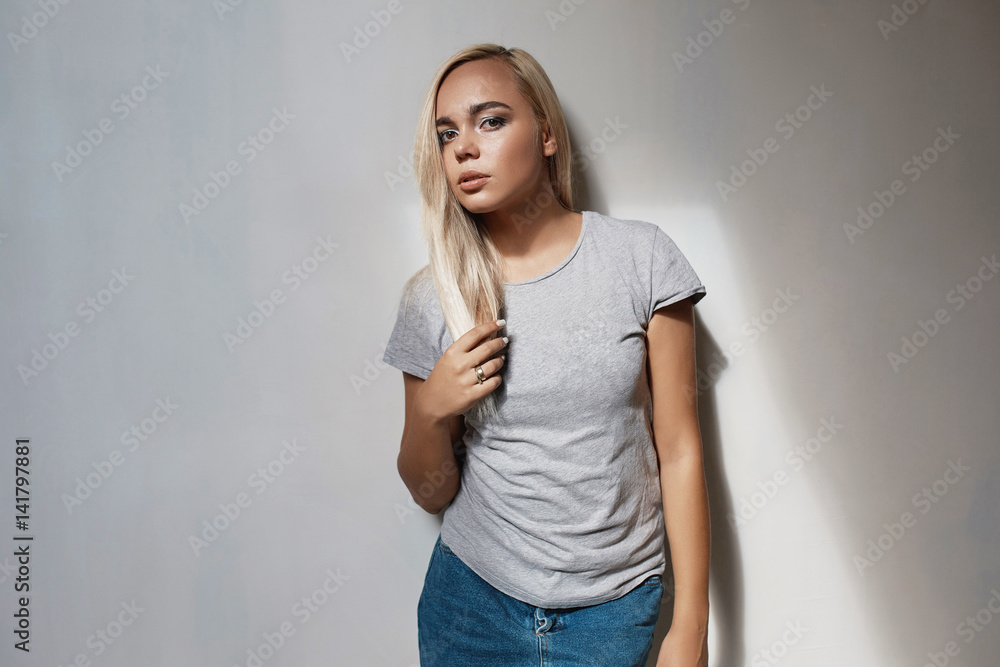 Pretty blonde woman posing in light room Pretty blonde woman posing in light room