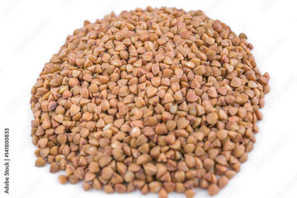 Handful of buckwheat on a white background, close-up Handful of buckwheat on a white background, close-up