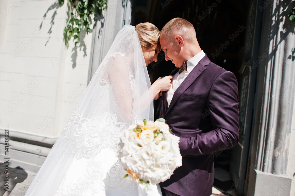 Bride tie buttonhole for her groom at wedding day. Bride tie buttonhole for her groom at wedding day.