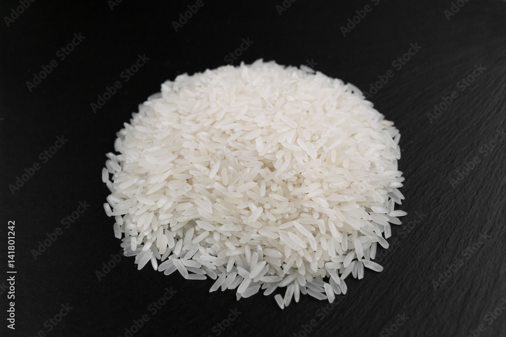 Hill rice grains on a black background, close-up Hill rice grains on a black background, close-up