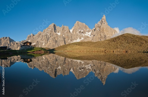 Passo Rolle, Dolomites, Trentino, Italy. The mountaingroup of Pala di San Martino  reflecting in the lake near Segantini Hut. From left Mulaz, Cima dei Bureloni, Cima Vezzana and Cimon della Pala. photo