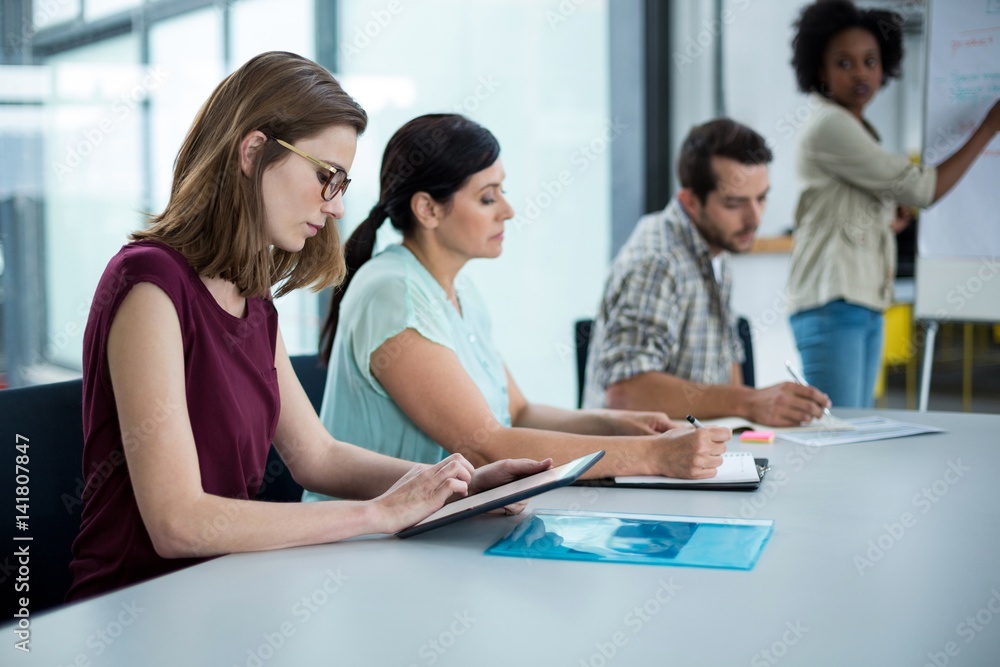 Business executive using digital tablet in meeting Business executive using digital tablet in meeting