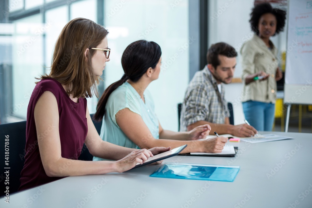 Business executive using digital tablet in meeting Business executive using digital tablet in meeting