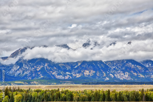 Clouds moving in to cover the Teton Mountain range.