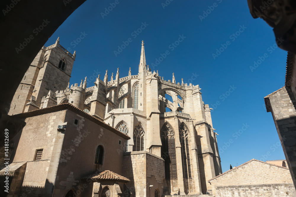 Architecture of Narbonne Cathedral  framed by vertical silhouette arch Narbonne, France.