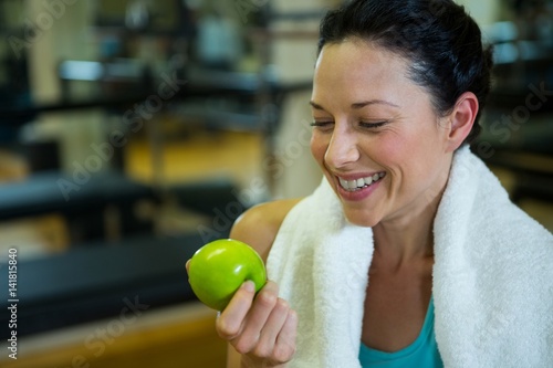 Fit woman holding green apple