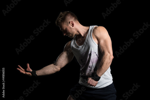 Young Bodybuilder Flexing Muscles Isolate On Black Blackground © Jale Ibrak