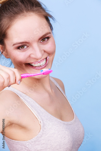 Woman brushing cleaning teeth