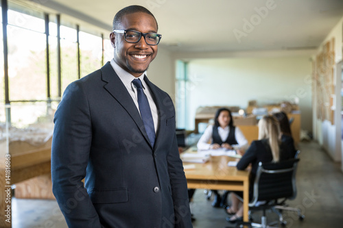 Smiling owner ceo at office work place portrait of worker in suit glasses and tie looking handsome