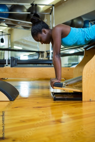 Determined woman exercising on wunda chair