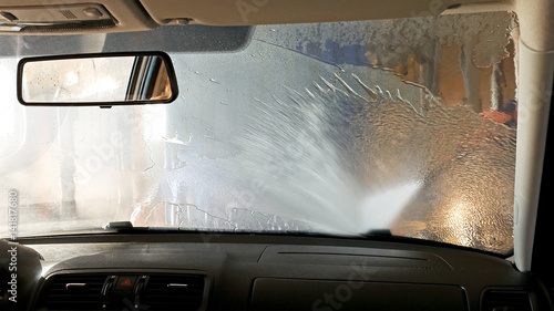 Automatic conveyorized tunnel car wash. A view from inside. photo