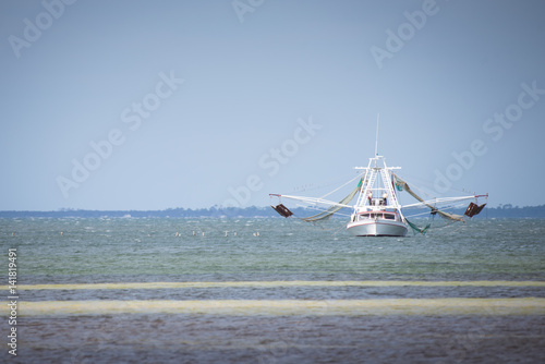 Shrimp boat in the ocean photo