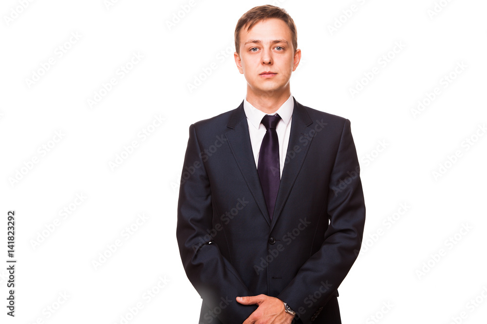 Young handsome businessman in black suit is standing straight, portrait isolated on white background Young handsome businessman in black suit is standing straight, portrait isolated on white background