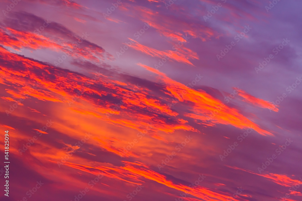 Nature background. Red sky at night and clouds. Beautiful and colorful sunset time.