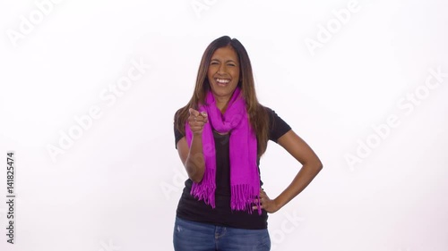 A woman points and laughs. Medium shot on white background.