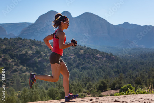 Woman Trail Running Outside Side View