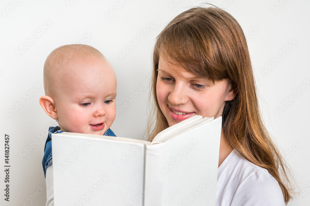 Smiling mother and her child reading a book Smiling mother and her child reading a book