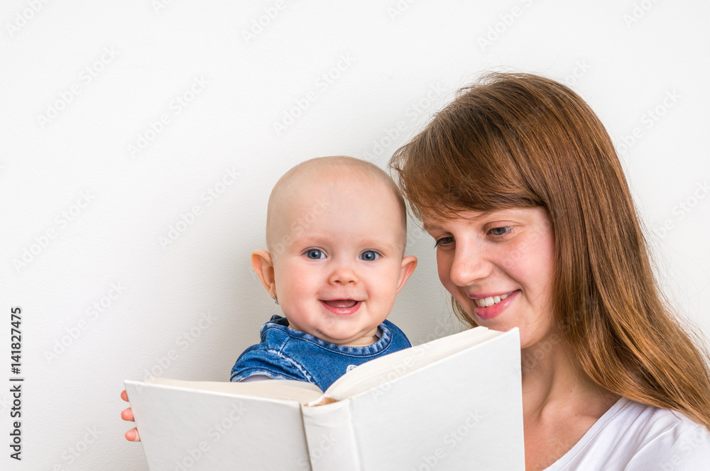 Smiling mother and her child reading a book Smiling mother and her child reading a book