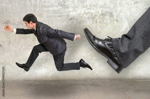 Small businessman running away from a boss pressure