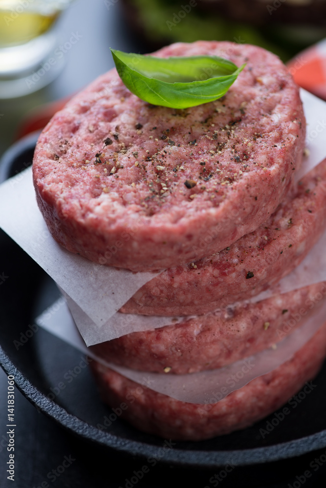 Raw burger cutlets made of minced beef meat, close-up, shallow depth of field