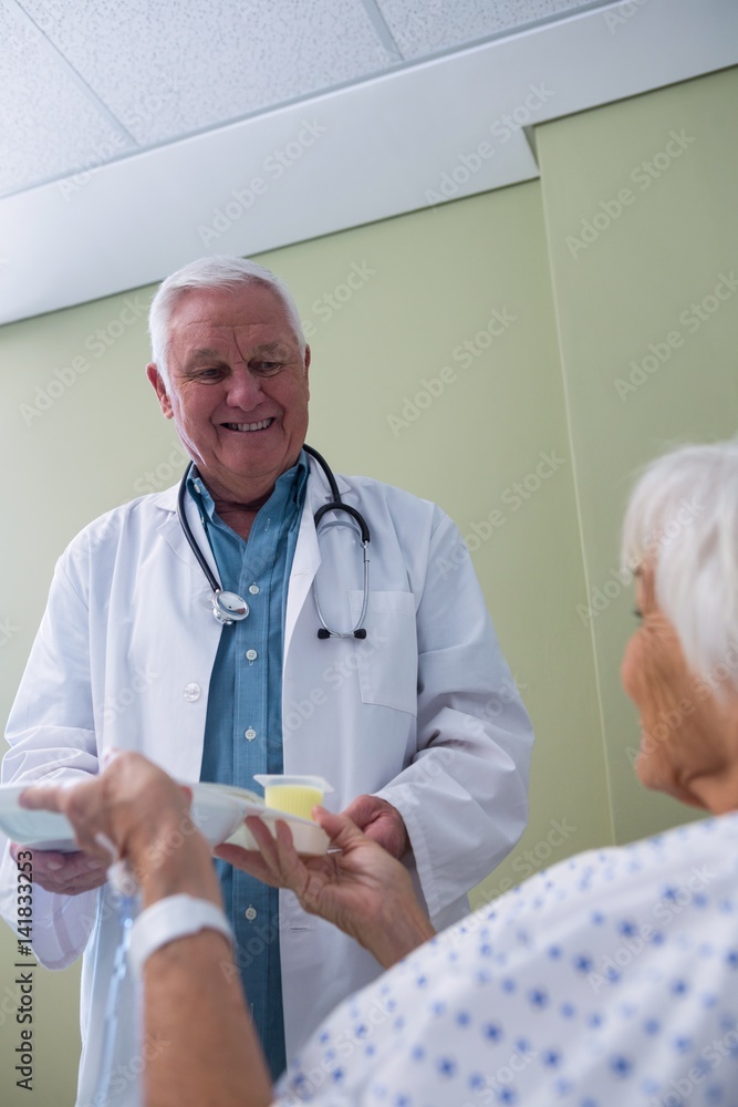 Doctor serving breakfast and medicine to senior patient Doctor serving breakfast and medicine to senior patient