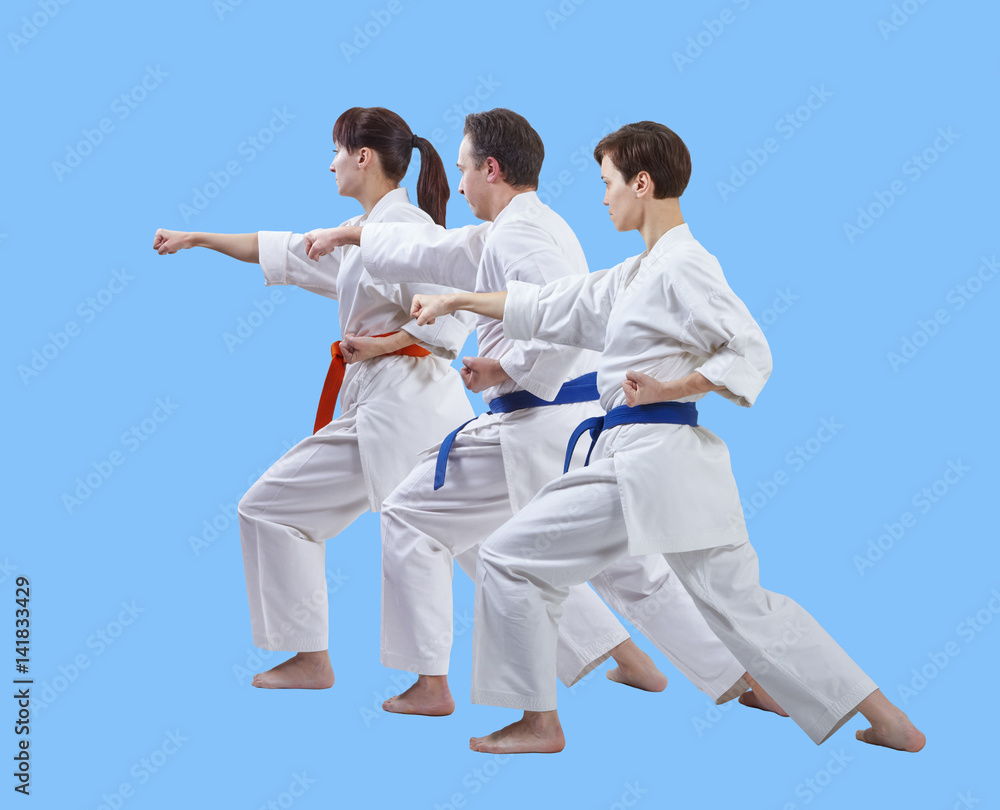 On a light blue background the athletes are beating punch arm On a light blue background the athletes are beating punch arm
