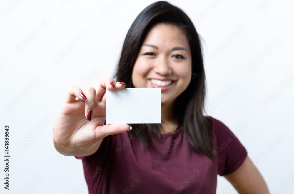 Smiling Chinese woman holding a business card Smiling Chinese woman holding a business card