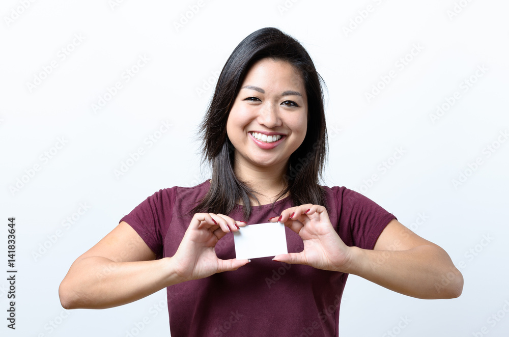 Smiling Chinese woman holding a business card Smiling Chinese woman holding a business card