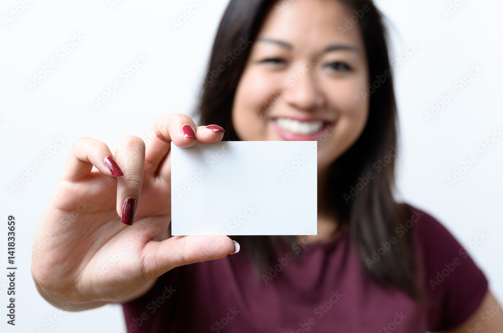 Smiling Chinese woman holding a business card Smiling Chinese woman holding a business card