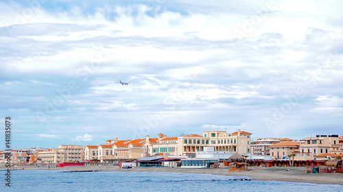 Plane over the coast. Ostia, Rome, Italy photo