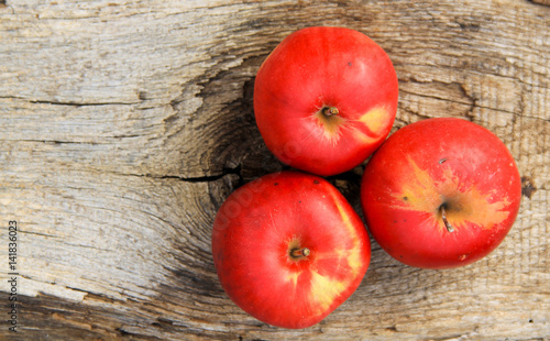 Red apples on wooden background