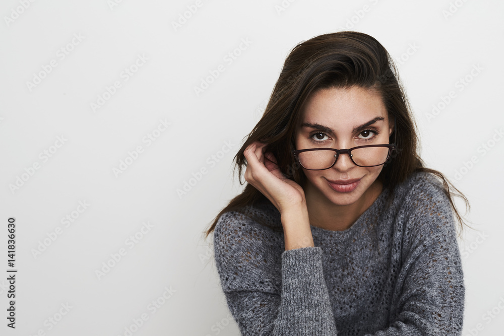 Beautiful woman in glasses looking to camera