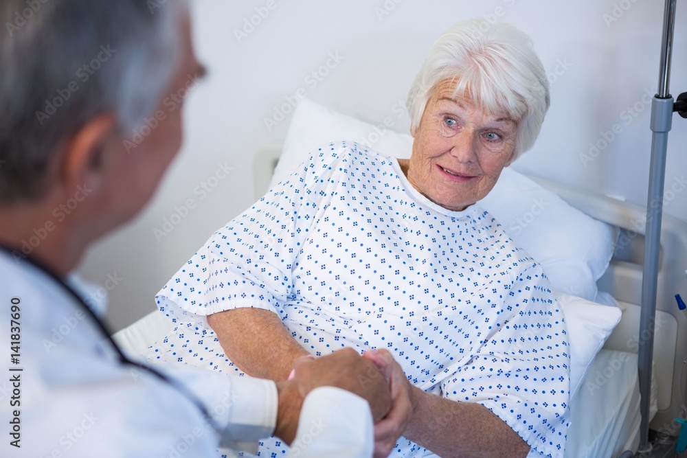 Doctor examining senior patient in ward Doctor examining senior patient in ward