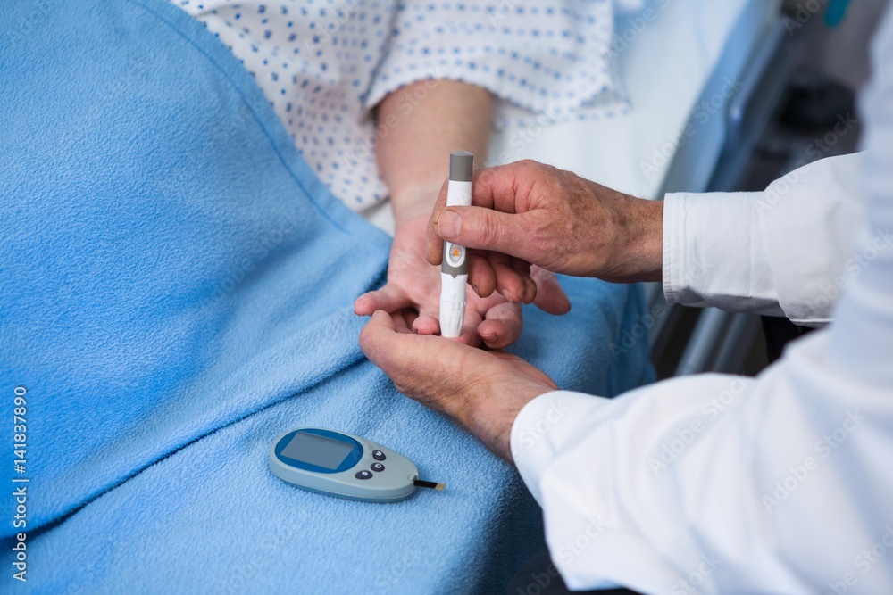 Doctor testing diabetes of senior patient with insulin pen Doctor testing diabetes of senior patient with insulin pen