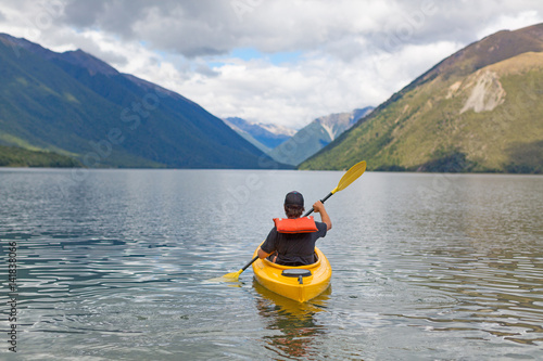 Man paddling kayak in mountain lake, Lake Rotoiti, New Zealand 