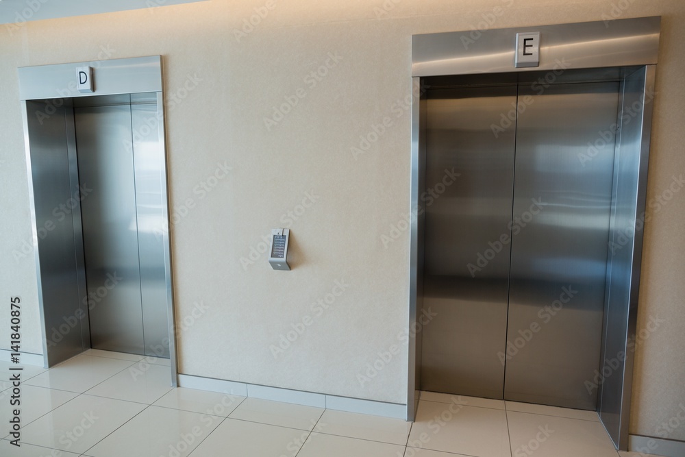 Two elevator doors in lobby of office building Two elevator doors in lobby of office building