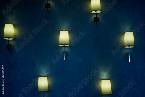 several luminaires on a textured dark blue background