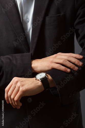Young man is looking at his watch