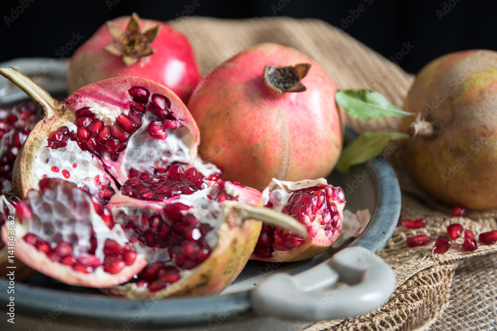 Pomegranate fruit arranged on wooden table top Pomegranate fruit arranged on wooden table top