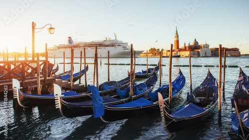 Gondolas in Venice - sunset with San Giorgio Maggiore church. Venice, Italy