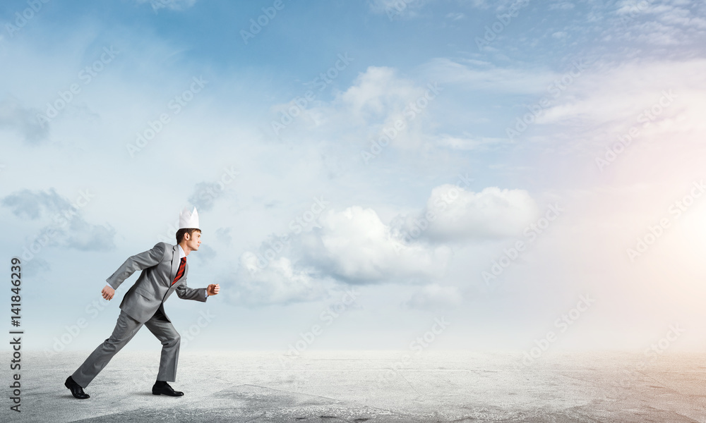 King businessman in elegant suit running and blue sky at background