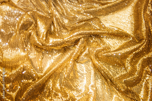 Golden sequins - sparkling sequined textile photo