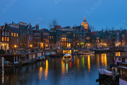 Canal in Amsterdam with houseboats in the evening, the Netherlands