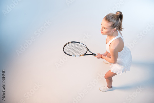 woman with tennis racket © LIGHTFIELD STUDIOS