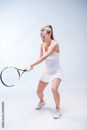 Young woman playing tennis © LIGHTFIELD STUDIOS