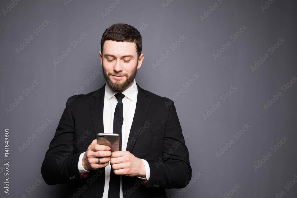 Handsome stylish young man writing sms on phone. Handsome stylish young man writing sms on phone.