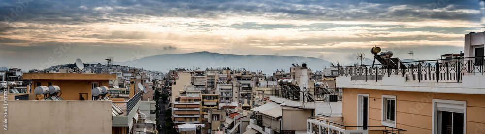 Panoramic view of sunset over the roofs in the city of Piraeus port in Greece Panoramic view of sunset over the roofs in the city of Piraeus port in Greece